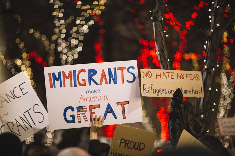 Protestors with signs in support of immigration. 