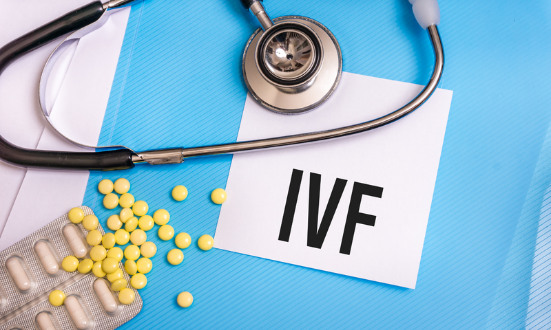 The image contains the acronym IVF, fertilization medicines, and a stethoscope.