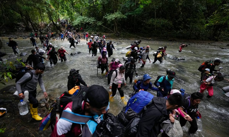 Immigrants crossing a river in the Darién Gap at the Panama border.