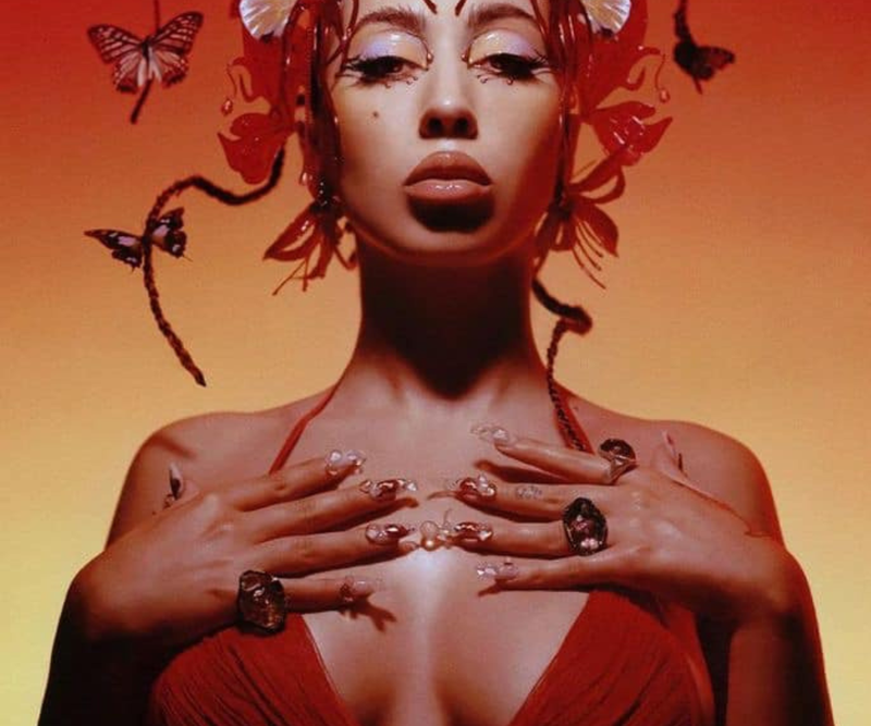 Kali Uchis, with vibrant butterflies in her hair