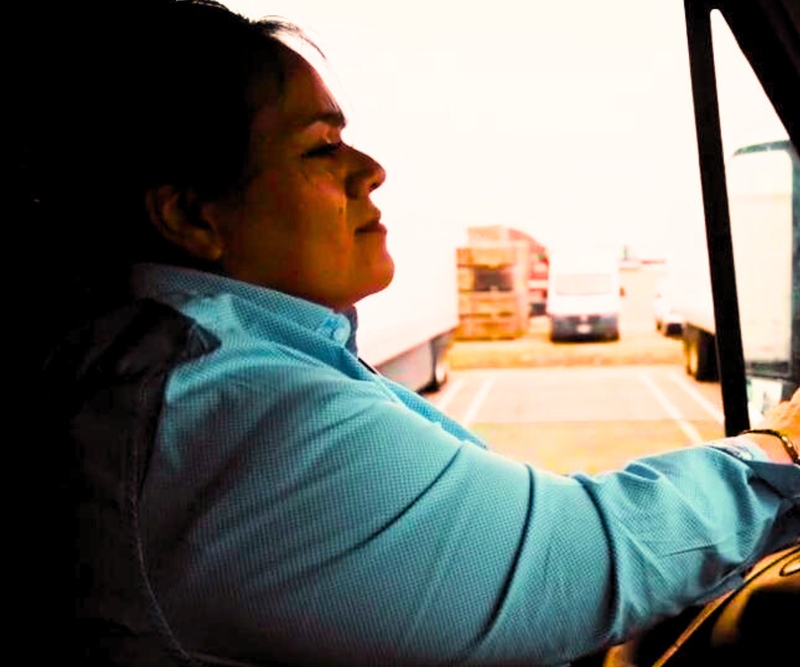 Laura Zúñiga driving a truck.